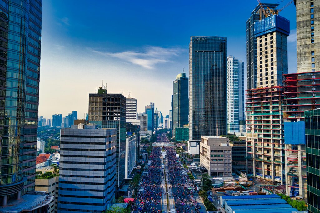 Stunning aerial view of Jakarta's modern skyline with bustling streets below.